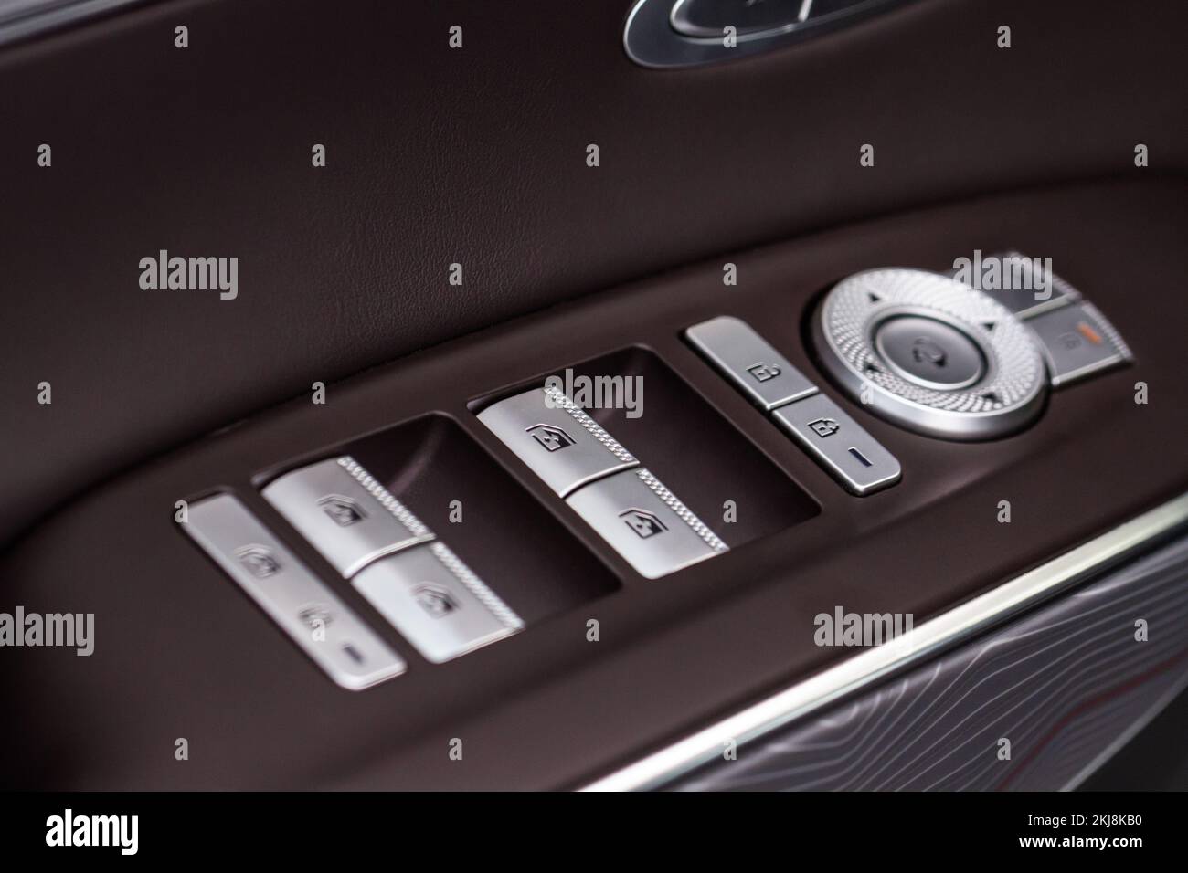 Close up view of button controlling window in modern car interior. Vehicle interior detail. Door handle with windows controls Stock Photo