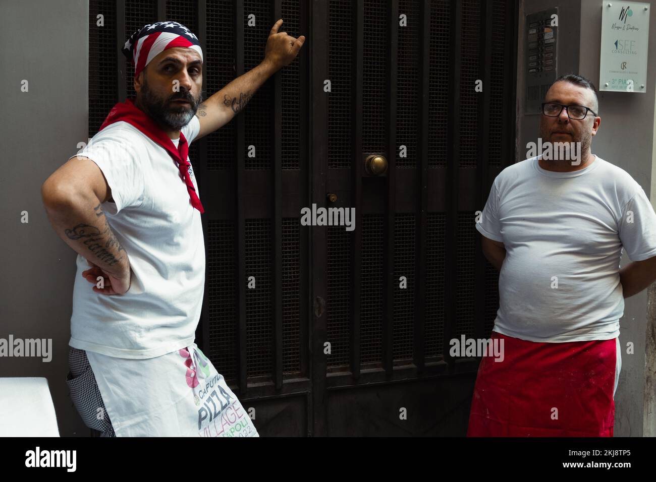 Posing of two pizza makers in their break time. Stock Photo