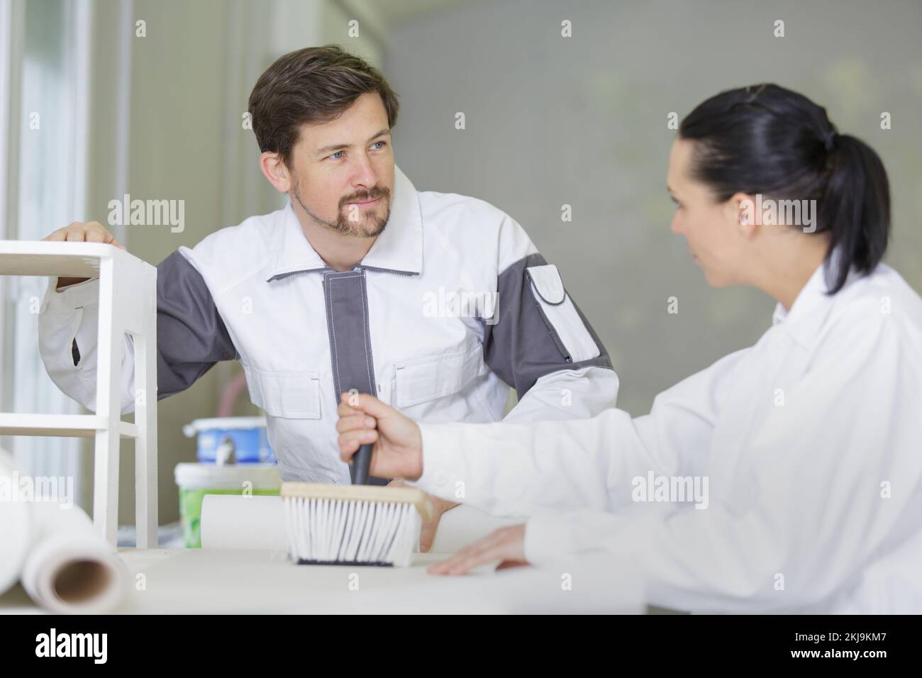 a team of painters decorating team pasting wallpaper Stock Photo