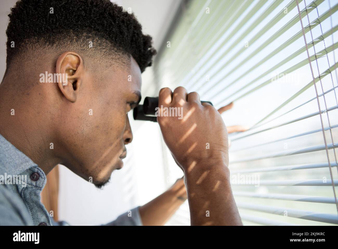 suspicious skeptic and confused man with binoculars Stock Photo Alamy