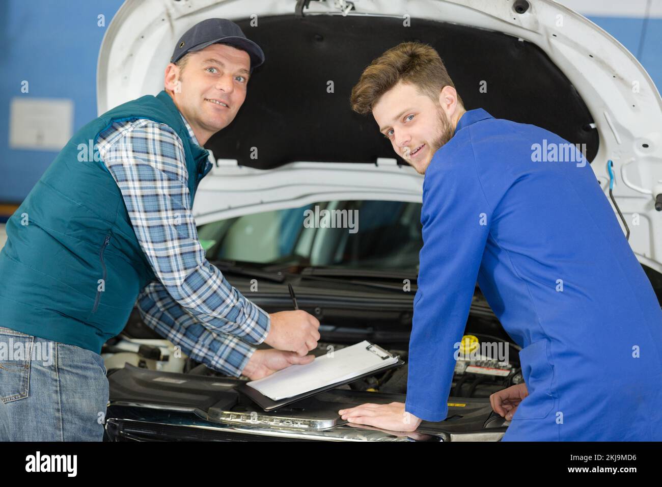 mechanic showing apprentice in doing diagnostic Stock Photo