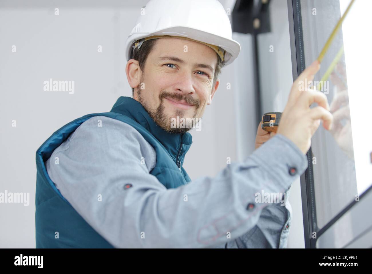 man measuring up a window Stock Photo - Alamy