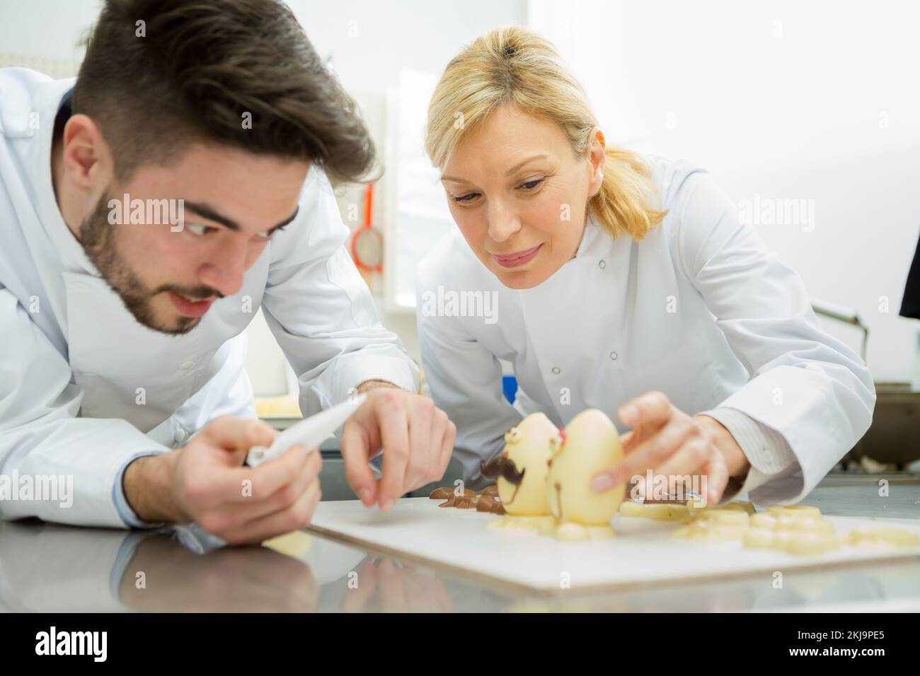 couple of confectioners making a dessert Stock Photo Alamy