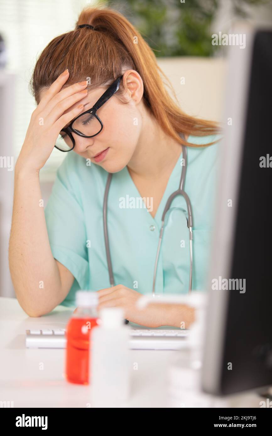 tired medical assistant in her office Stock Photo