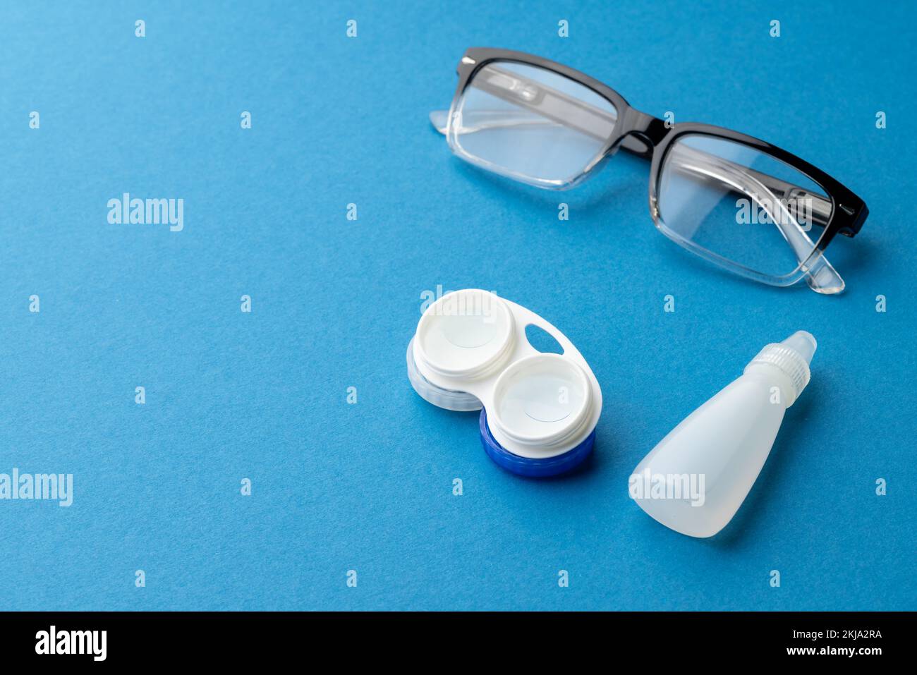 Composition of glasses with contact lenses case and eye drops and on