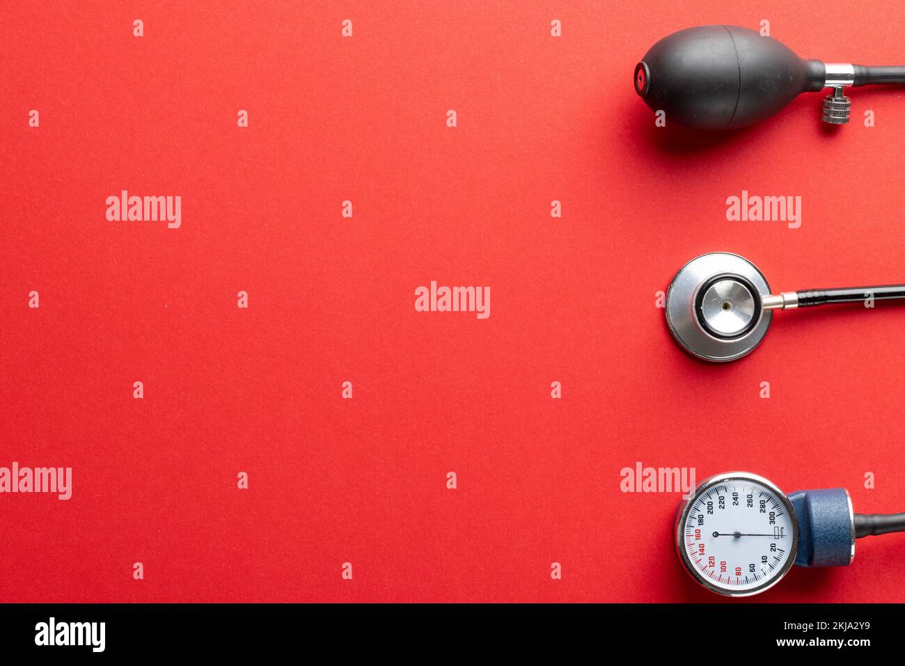 https://c8.alamy.com/comp/2KJA2Y9/composition-of-sphygmomanometer-and-stethoscope-on-red-background-with-copy-space-2KJA2Y9.jpg