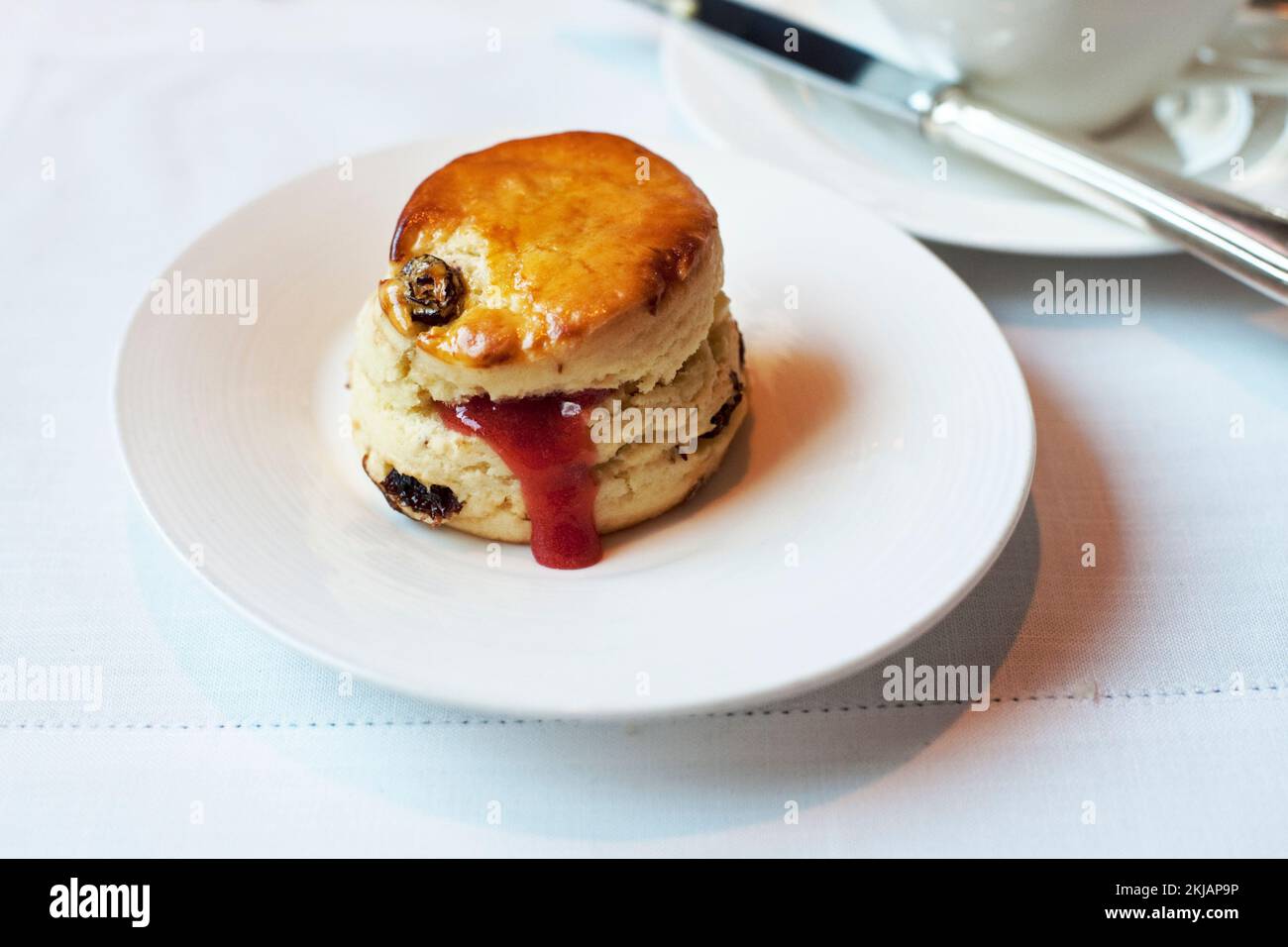 A raisin scone served with raspberry jam is an elegant part of high tea at Hullett House, Hong Kong, 2012 Stock Photo