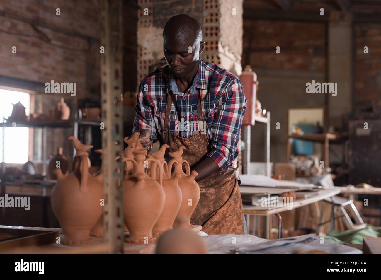 Potter checking clay products Stock Photo Alamy