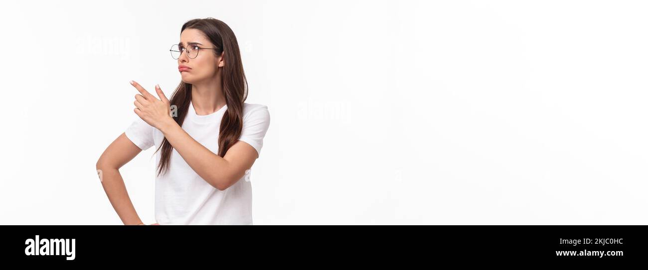 Waist-up portrait of pity or jealous young brunette female student missed great opportunity, feel regret and uneasy emotion, sulking grieving pointing Stock Photo