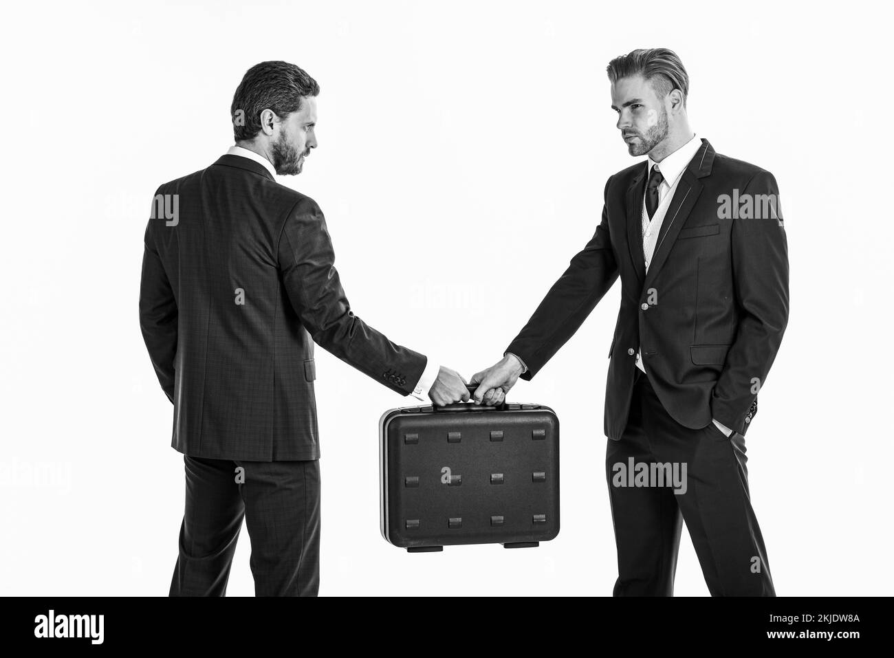 Business exchange concept. Handover of suitcase in hands of part Stock