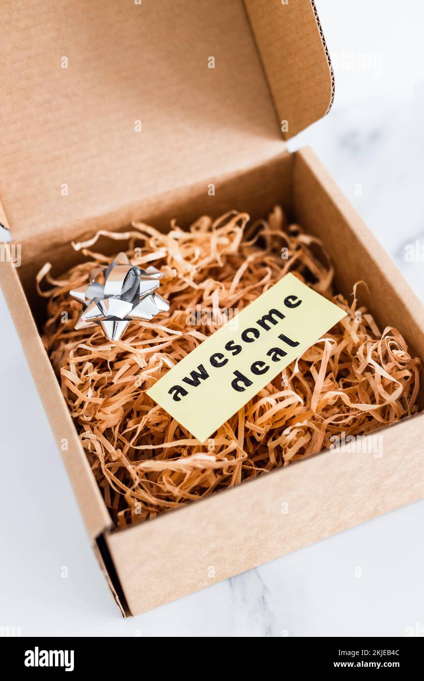 promotions and shopping over the festive season, parcel or gift box with Awesome Deal label inside of it Stock Photo