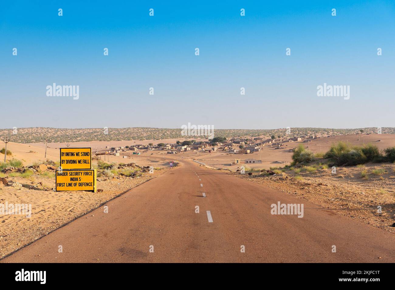 Milestone by BSF, Border security force, beside with empty high road or national high way passing through the desert. Distant horizon, Hot summer at T Stock Photo