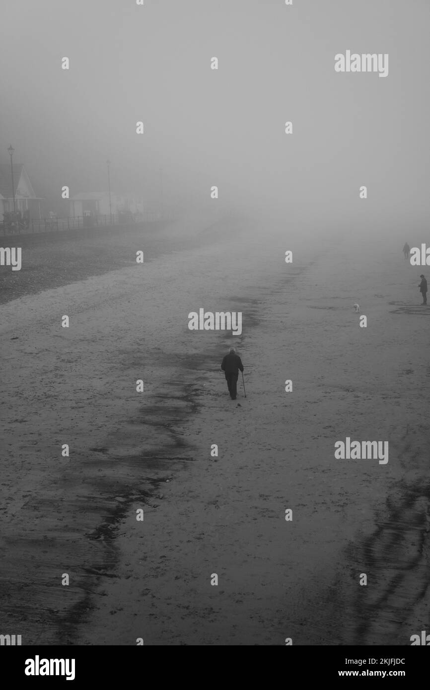 A silhouette of a man walking alone in foggy and snowy weather Stock ...