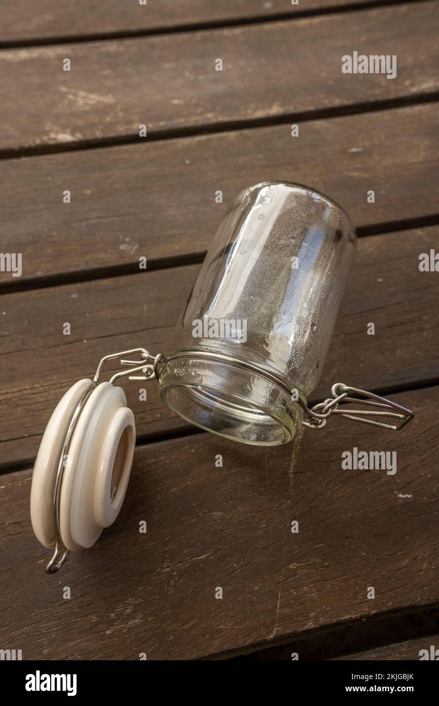 Empty glass jar with vacuum seal on acacia wood planks Stock Photo