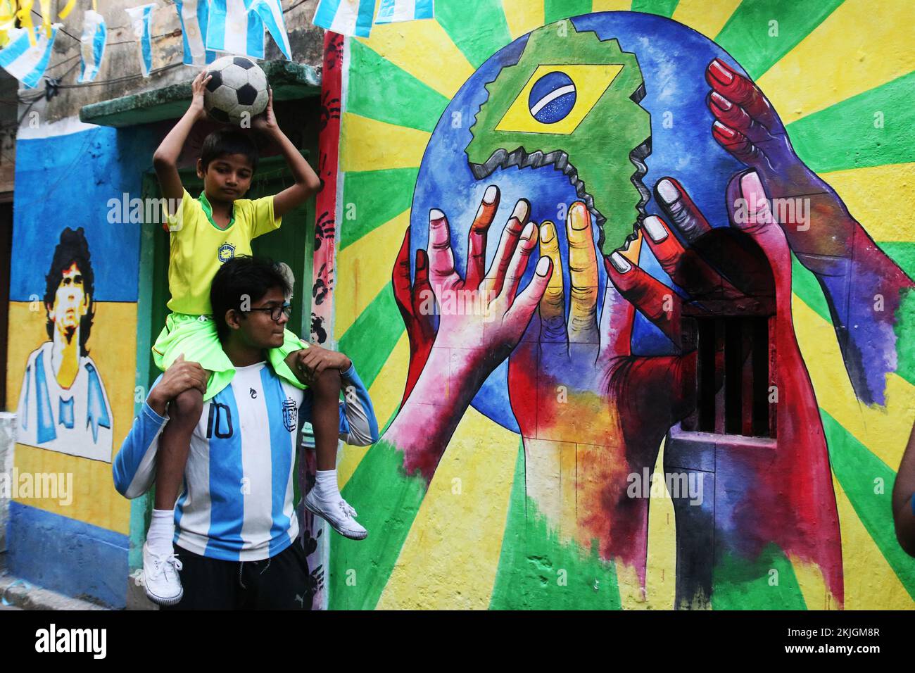 Kolkata, India. 24th Nov, 2022. indian Brazil and Argentina supporters with Football in front of wall graffiti celebrating ahead of the Qatar 2022 FIFA World Cup football tournament, in Kolkata on November 24, 2022. (Photo by Dipa Chakraborty/Pacific Press) Credit: Pacific Press Media Production Corp./Alamy Live News Stock Photo
