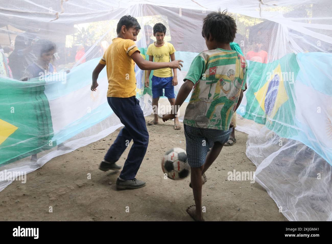 Kolkata, India. 24th Nov, 2022. Street Childrens playing football inside a big size mosquito net during awareness program of Prevent dengue and celebrating ahead of the Qatar 2022 FIFA World Cup football tournament, in Kolkata on November 24, 2022. (Photo by Dipa Chakraborty/Pacific Press) Credit: Pacific Press Media Production Corp./Alamy Live News Stock Photo