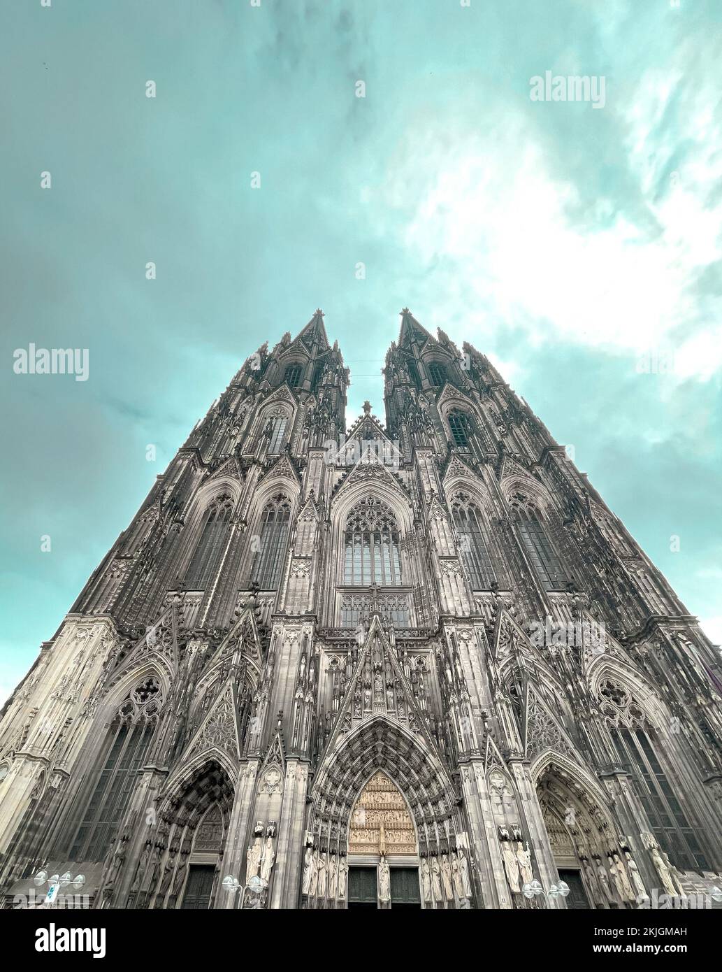 A low angle shot of the Cologne Cathedral with a cloudy sky above Stock ...