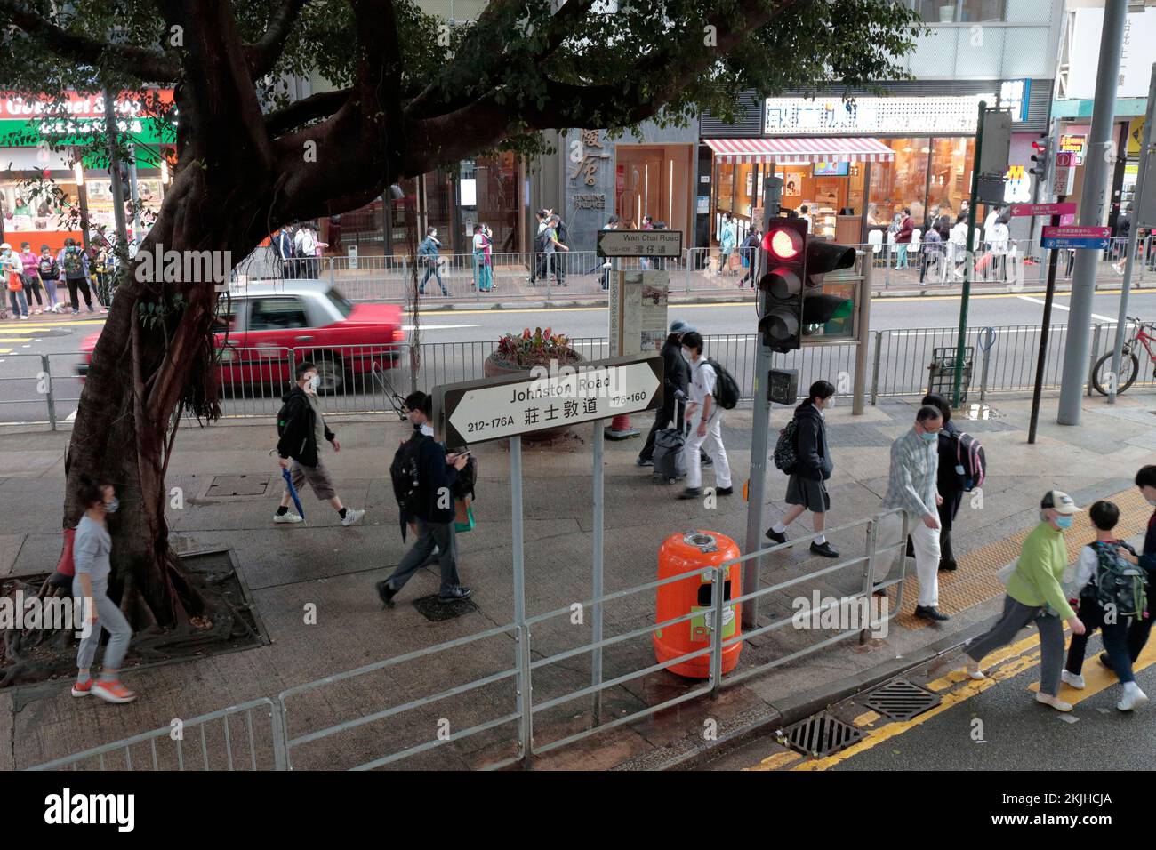 View of pedestrians on pavement near junction, Wan Chai Road and Johnstone Road, Wanchai, Hong Kong 24 Nov 2022 Stock Photo