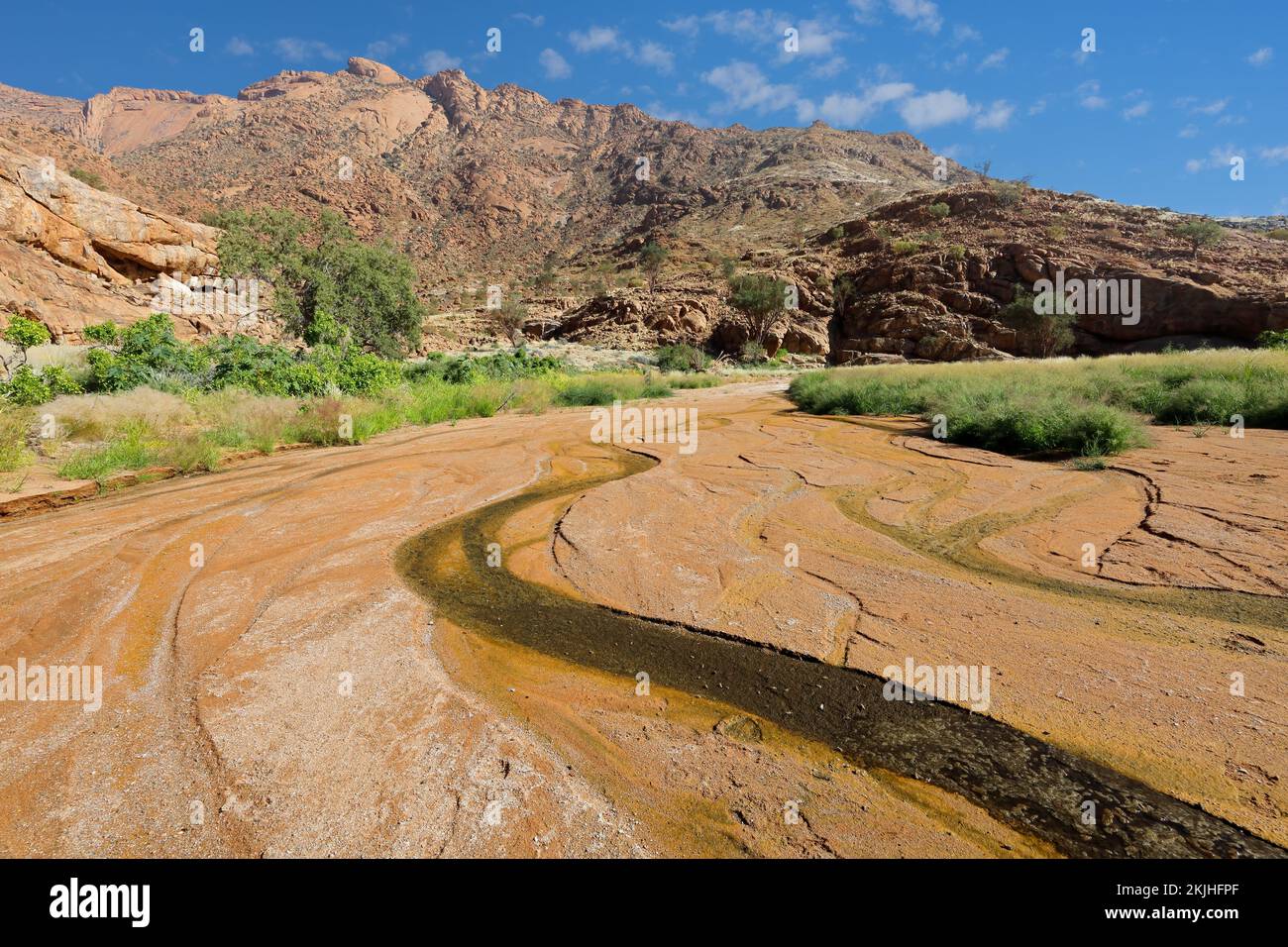 Meandering ephemeral river in the rugged landscape of the Brandberg mountain, Namibia Stock Photo