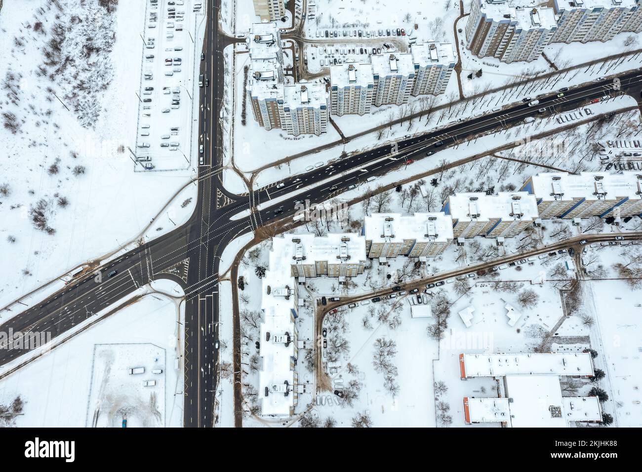 aerial top view of winter cityscape with road intersection and cars traffic. drone photo. Stock Photo