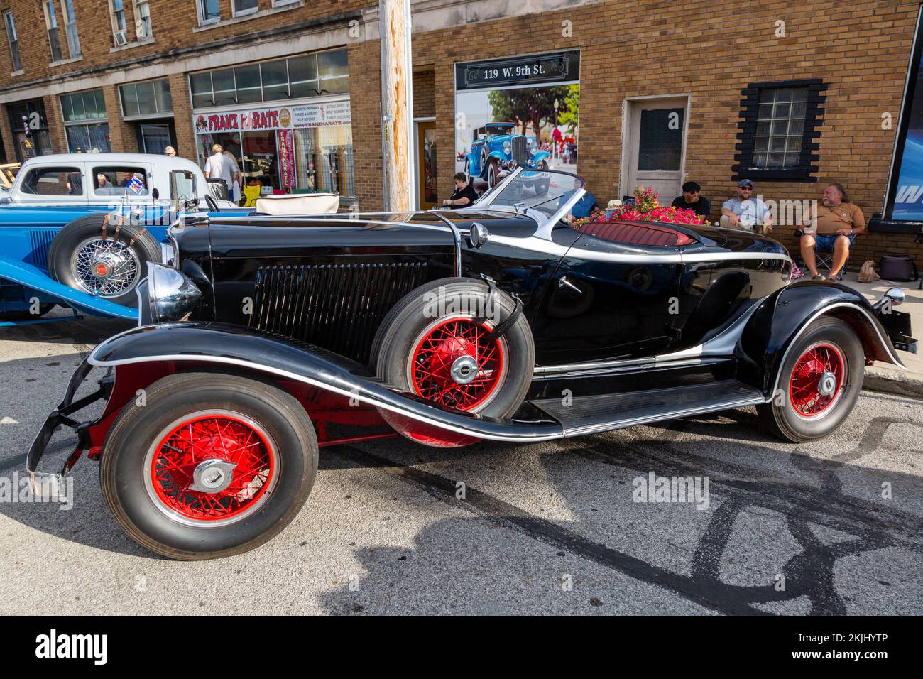 An antique black Auburn Speedster Boattail on display at a car show in
