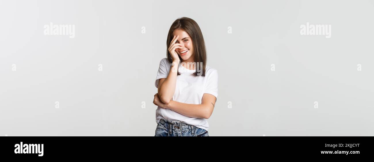 Flirty and silly girl blushing and smiling coquettish Stock