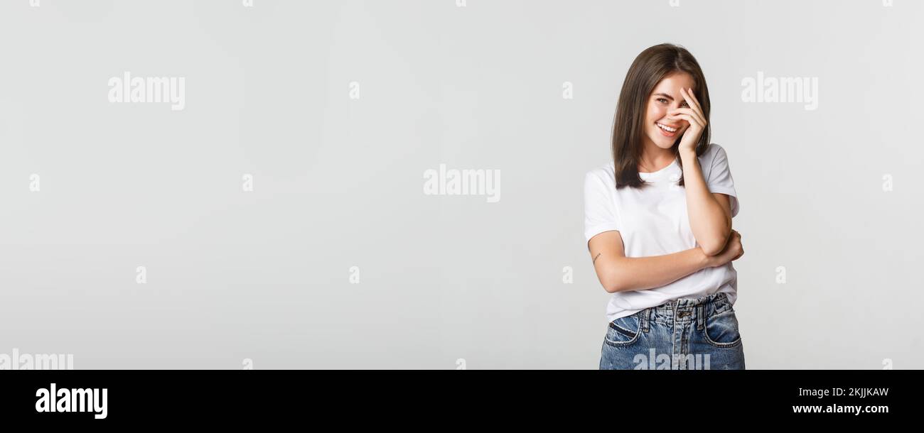 Flirty and silly girl blushing and smiling coquettish Stock