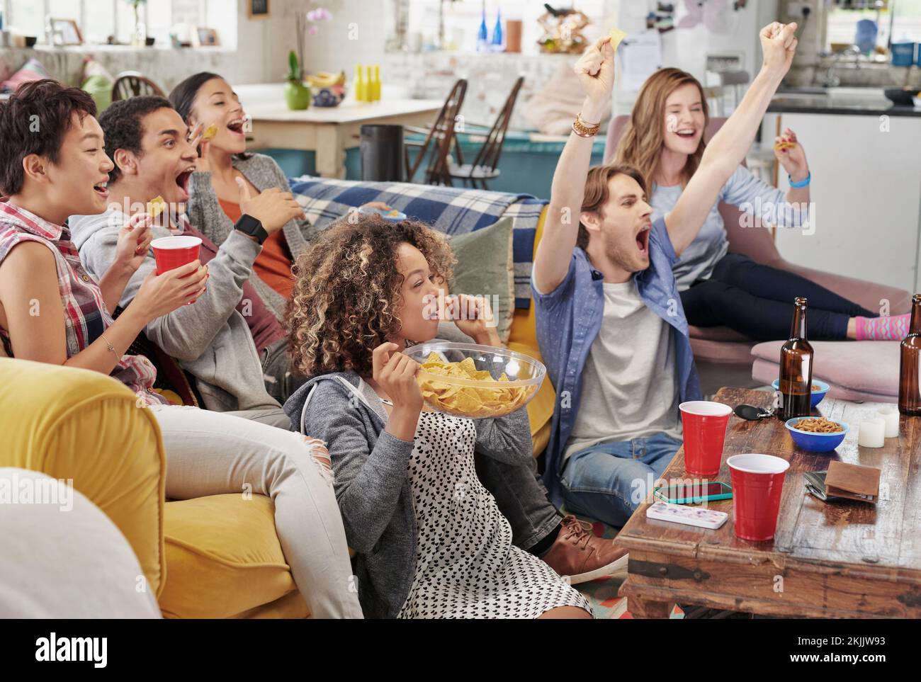 Celebration, diversity and excited people watching tv, global sports event or world cup competition winner. Pride, wow goals and team support energy Stock Photo