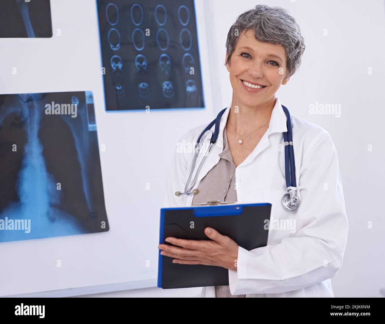 The best radiologist around. a female doctor studying x-rays Stock ...
