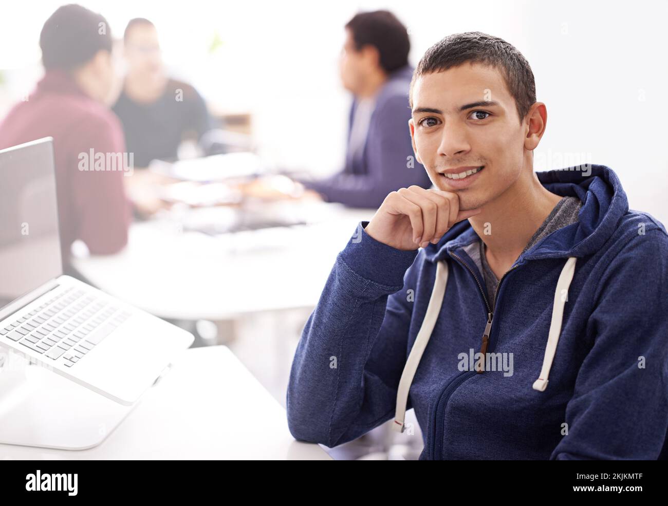 We practice excellence in everything we do. Portrait of a confident young man working on his laptop in an office. Stock Photo