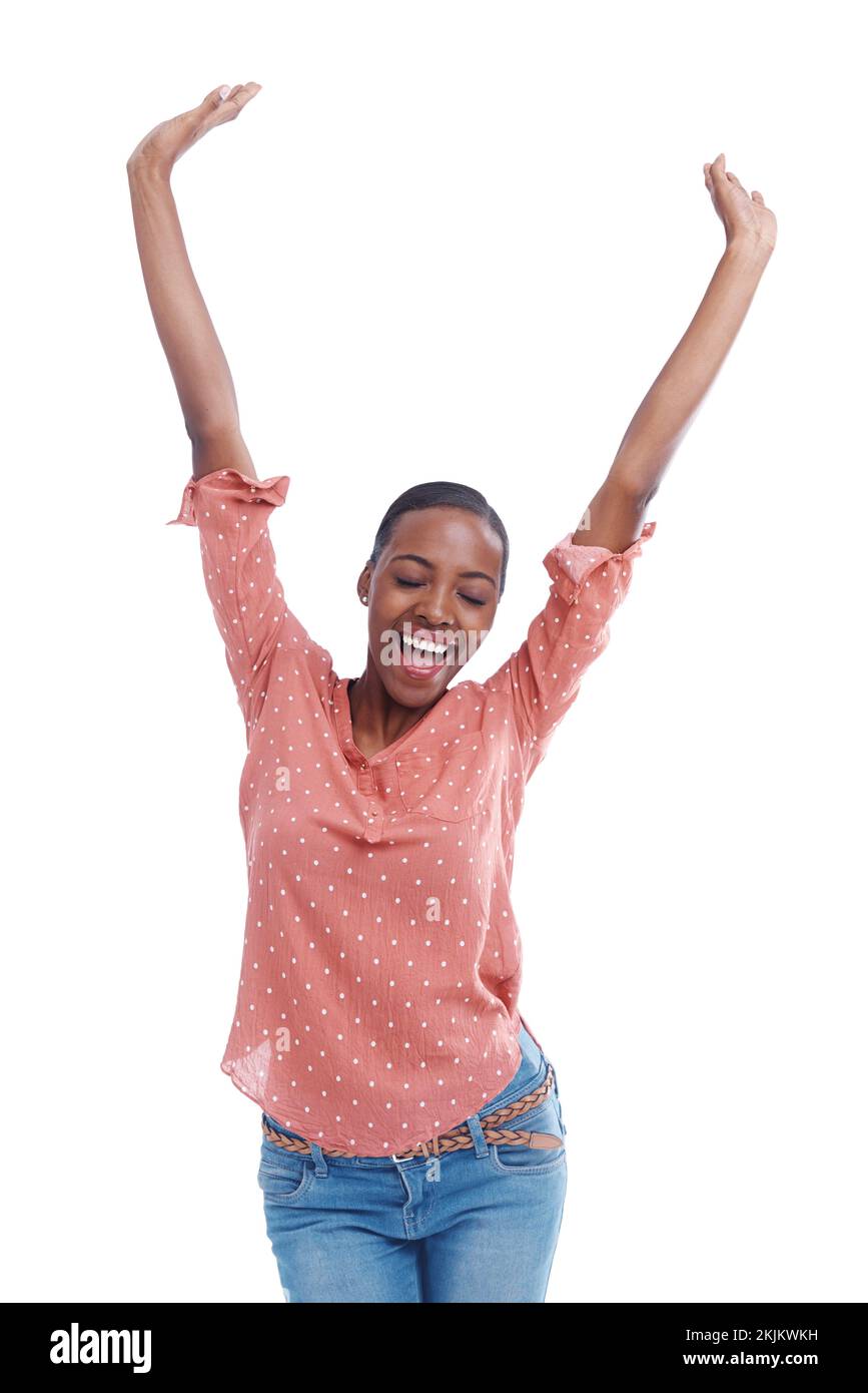 Im the winner. Studio shot of a young woman with arms raised in celebration. Stock Photo
