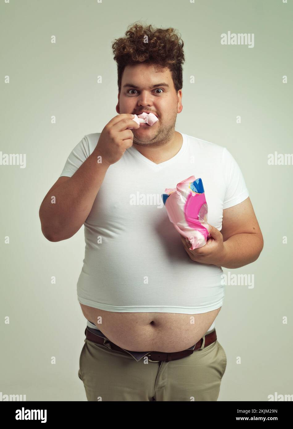 Must have more marshmallows. an overweight man with marshmallows shoved