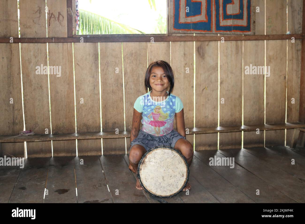 Indigenous people, little native girl Huni Kuin sitting on his drum in ...