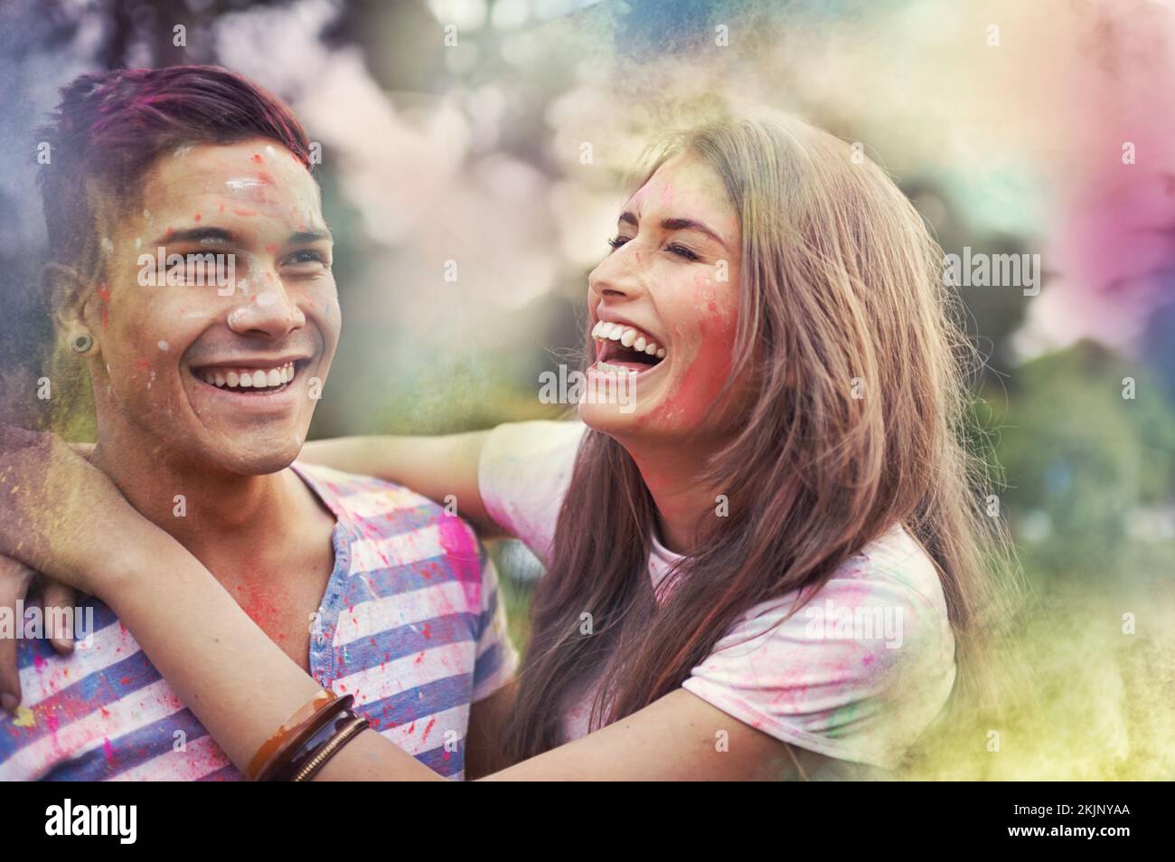 Couple in color. happy friends having fun with powder paint Stock Photo