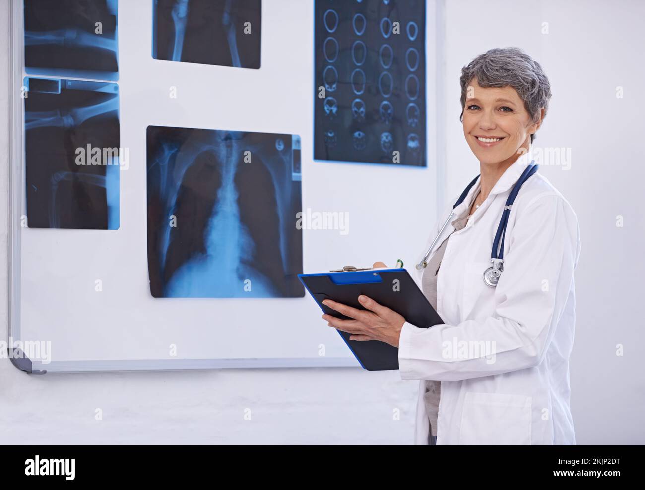 Radiology is her specialty. a female doctor studying xrays Stock Photo