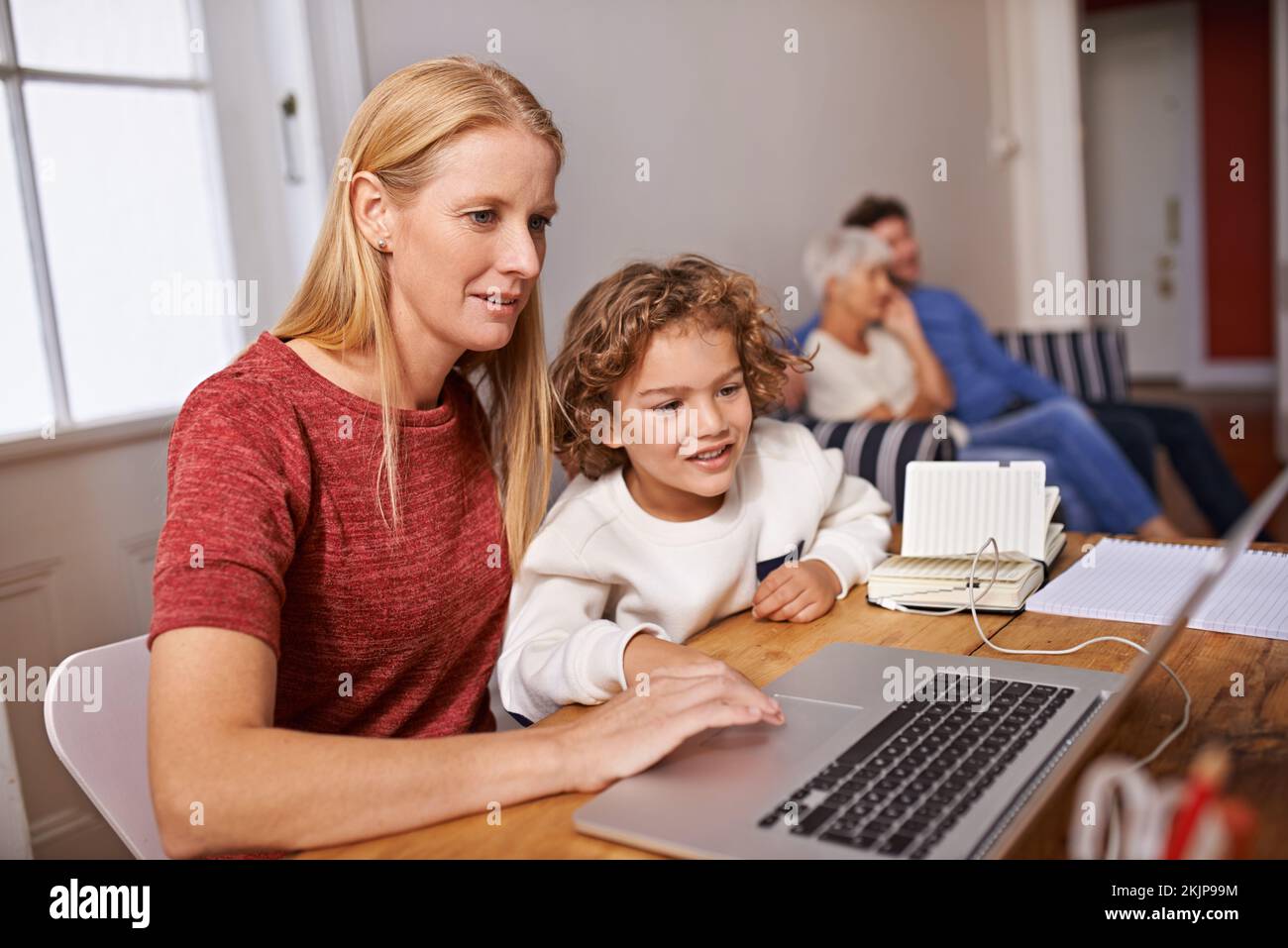 Learning about all sorts of stuff on the web. a mother and her son looking at something on a laptop screen. Stock Photo