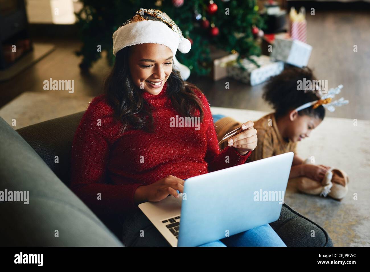 Christmas online shopping, e commerce and woman with credit card and laptop for internet and payment online. Holiday retail sale, family and ecommerce Stock Photo