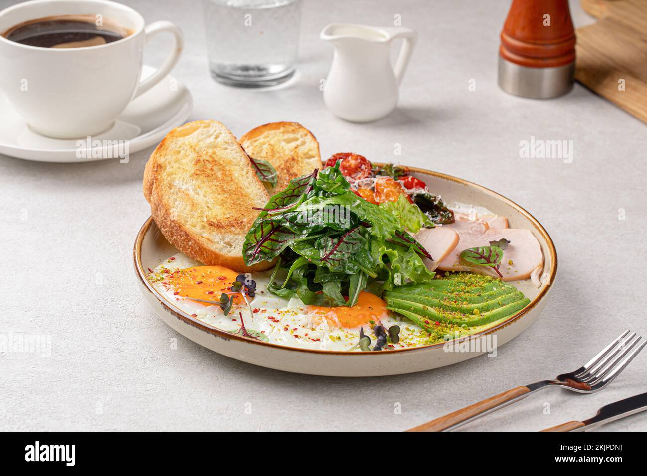 Fried eggs breakfast with salad and avocado Stock Photo