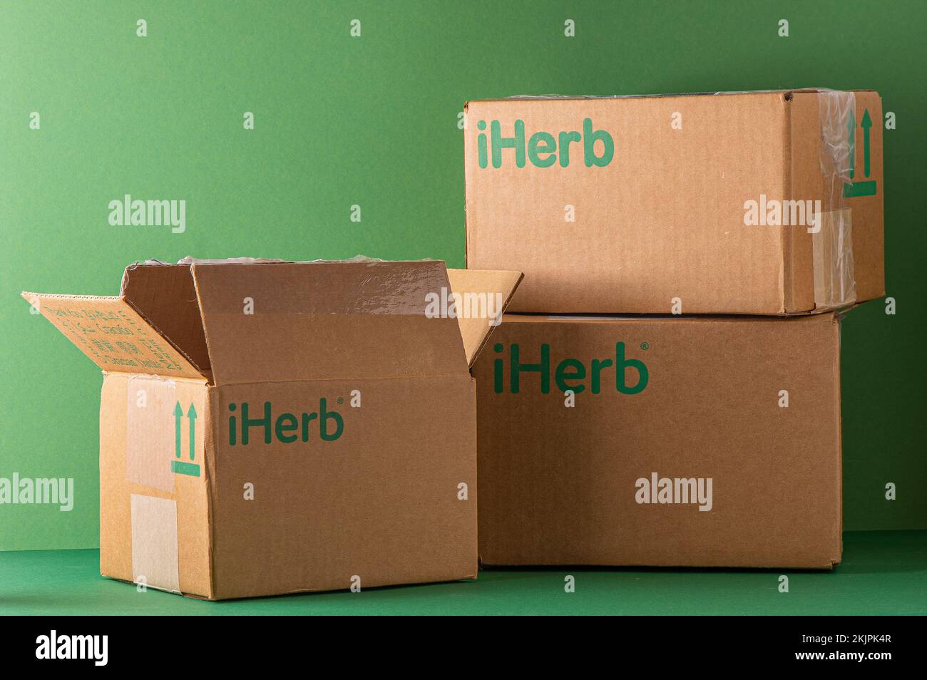 Delivery of Iherb vitamins by mail. Cardboard boxes with green logo. Open box. Shopping online for vitamin supplements. dietary supplement. Medicines for health. Kyiv, Ukraine - July 13, 2022 Stock Photo
