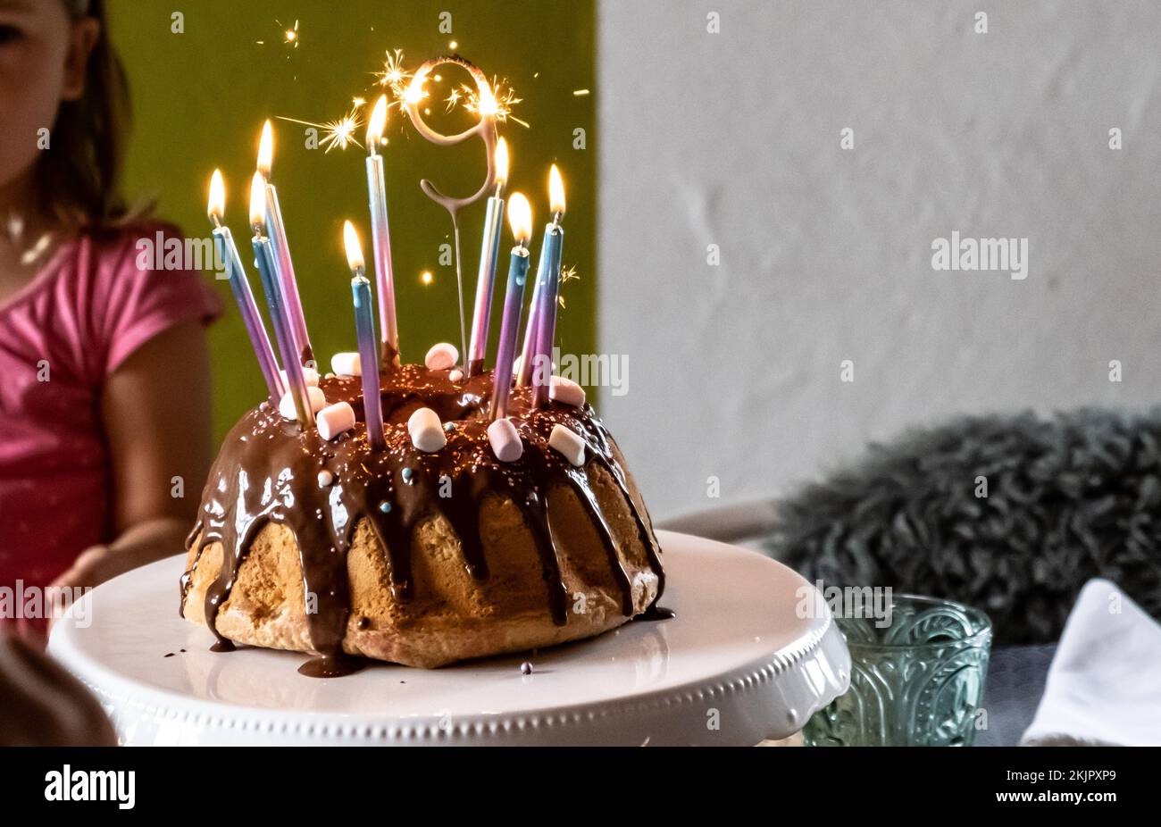 A chocolate birthday cake with lighted candles Stock Photo - Alamy