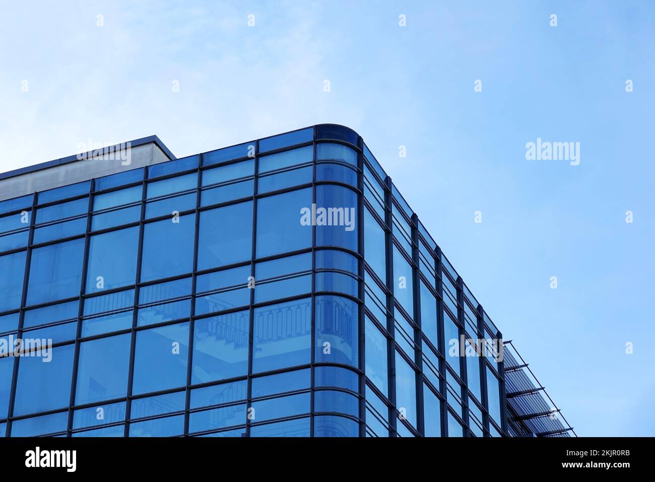 modern glass facade office building against blue sky Stock Photo