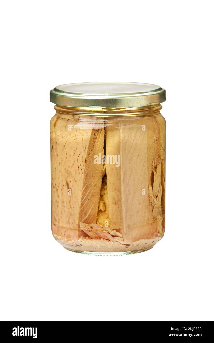 Preserved tuna fish fillets in a glass jar. Isolated on white