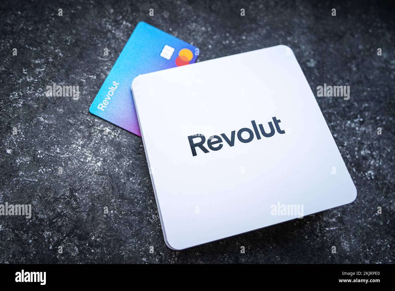 Revolut Bank card with the white envelope. New redesigned Revolut Mastercard without card details on concrete background. Krakow, Poland - November 11, 2022. Stock Photo