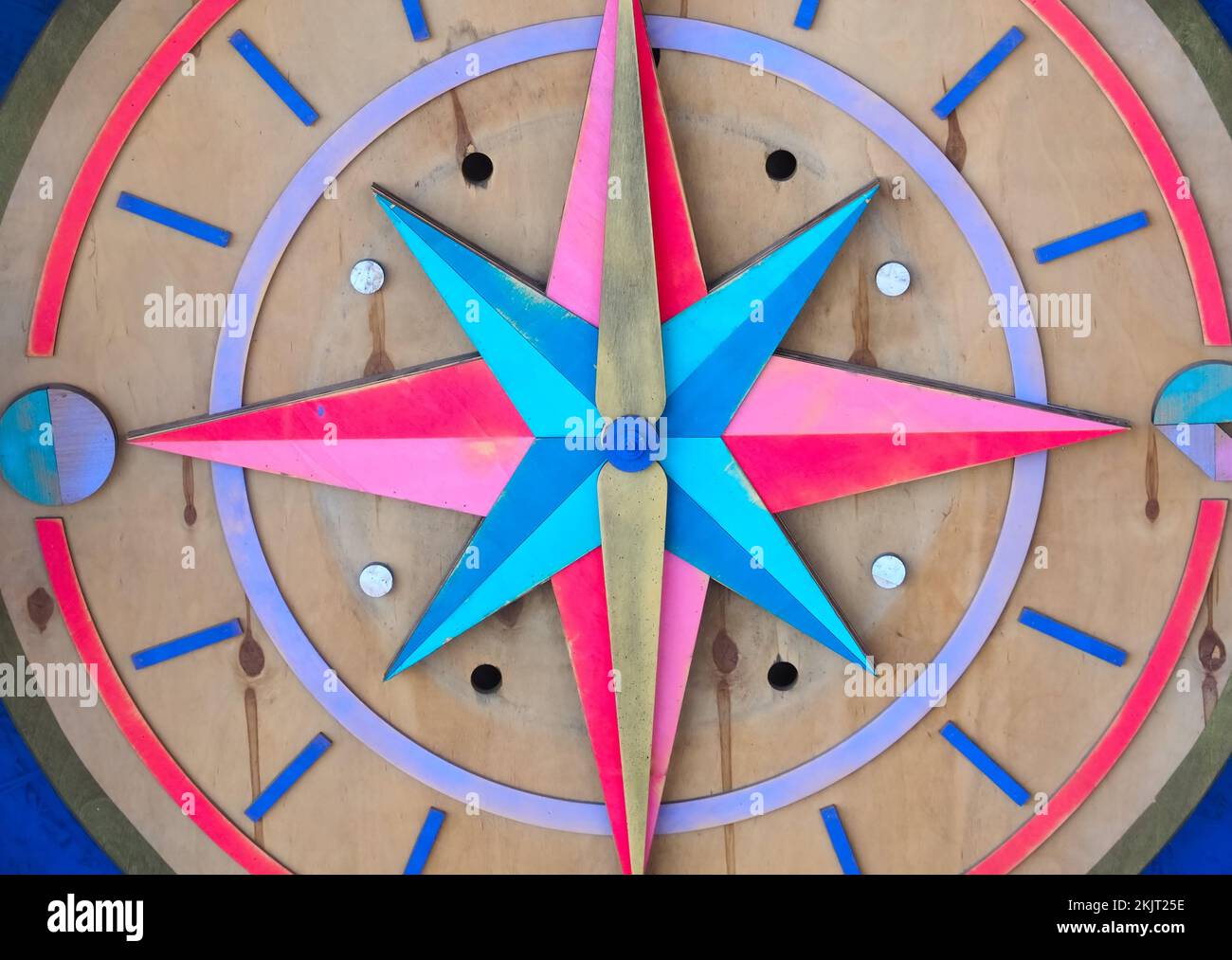Colored wooden compass shows cardinal direction Stock Photo Alamy