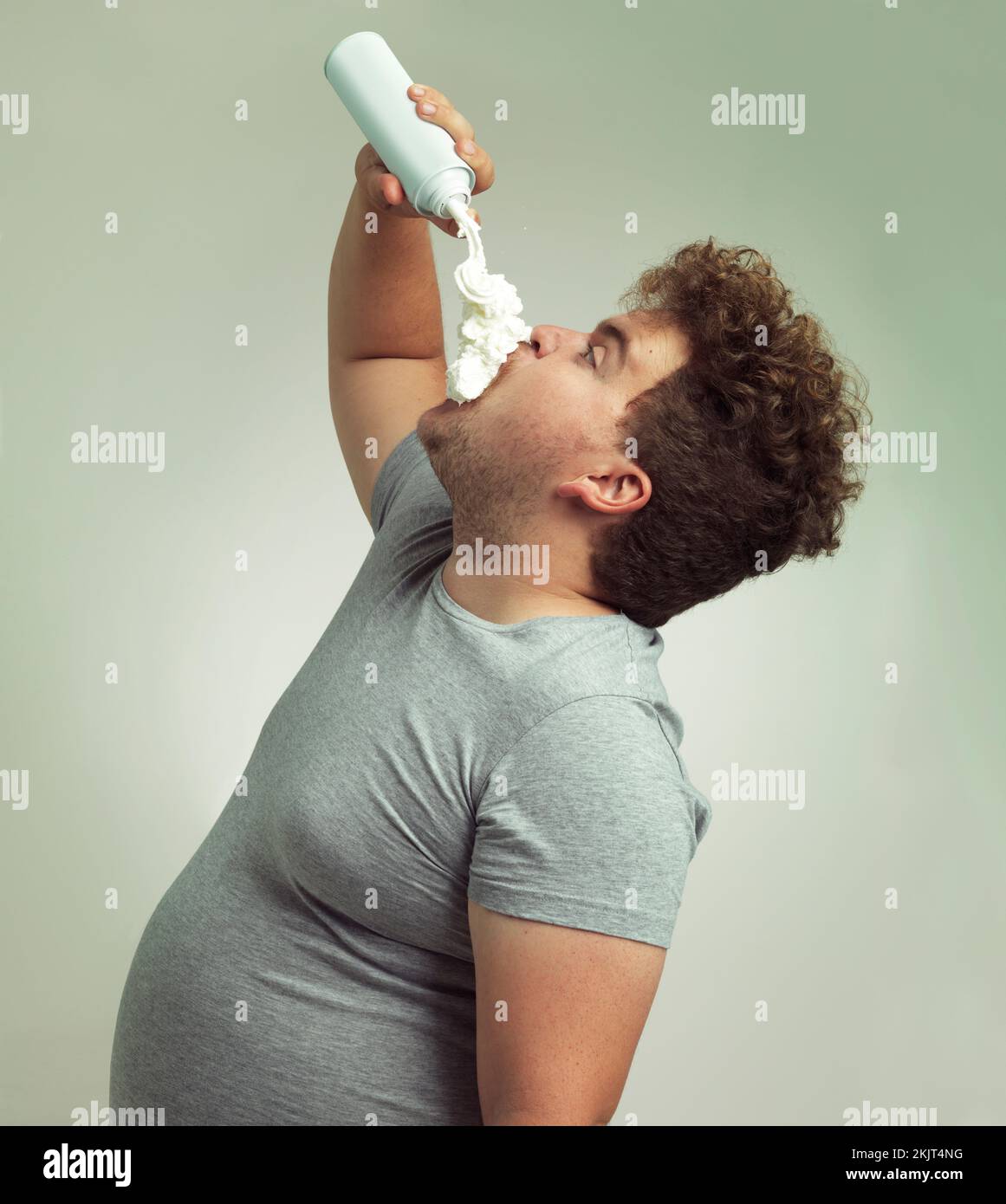 Im on the whipped cream diet. an overweight man filling his mouth with