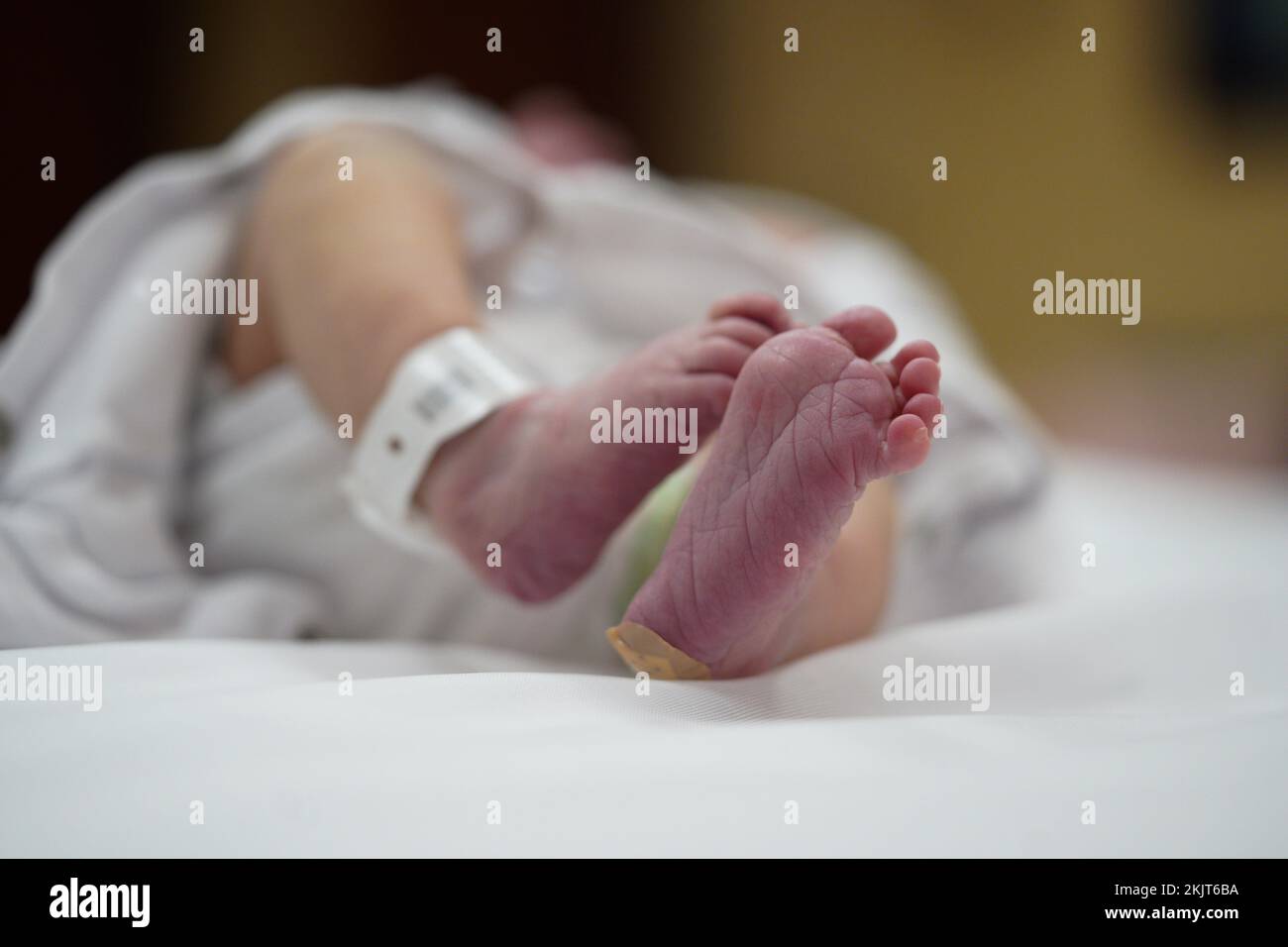 Newborn baby foot with identification bracelet in the hospital Stock