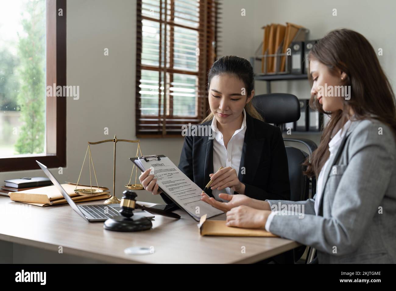 Consultation of Businesswoman and female lawyer or judge counselor having team meeting with client, Law and Legal services concept. Stock Photo