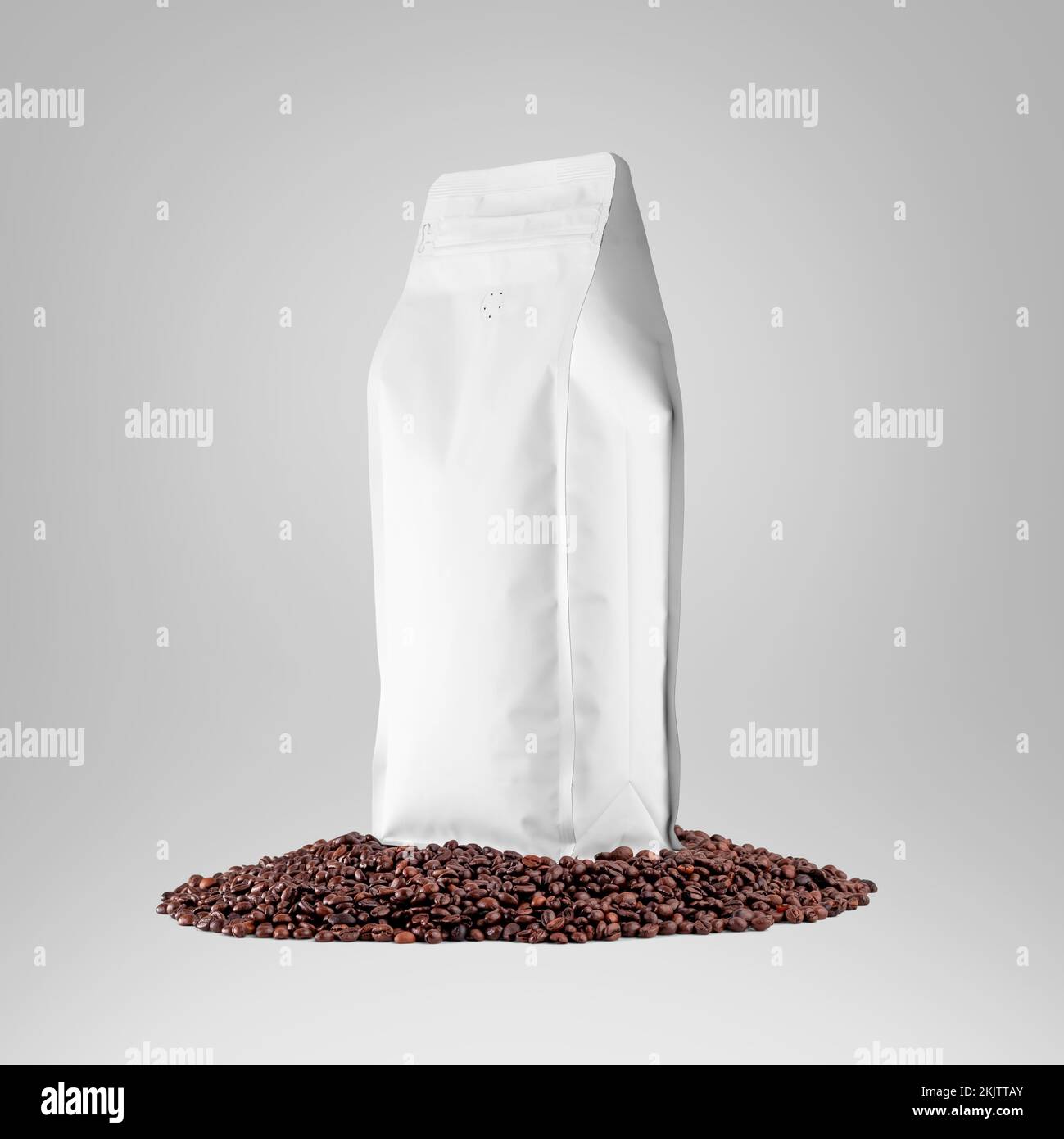 Mockup of a white bag standing on coffee beans, front view, side view, stabilo coffee pouch, isolated on background, close-up. Package template with d Stock Photo