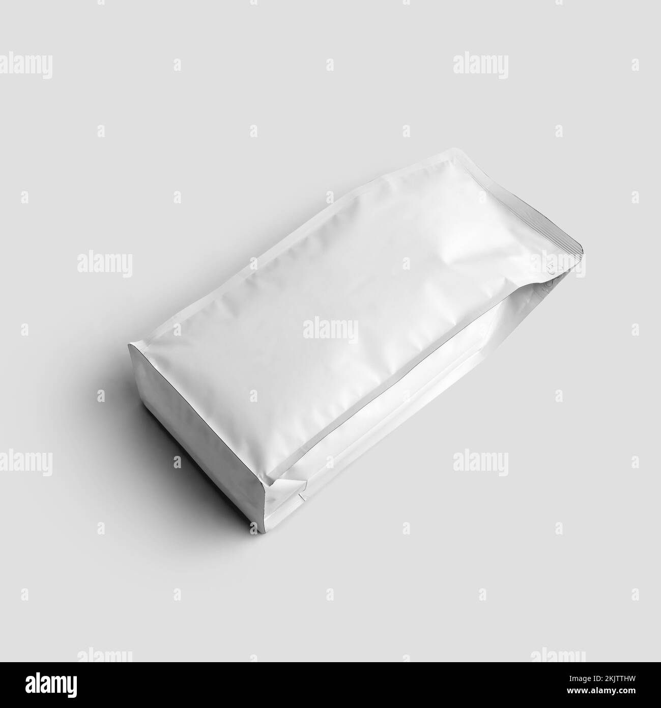 Template of a white sealed bag for coffee beans, tea, packaging with a clamping tape, isolated on a background. Close-up doypack mockup with space for Stock Photo