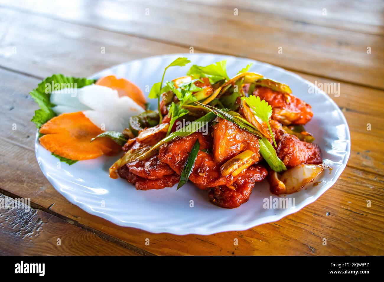 Spicy Nepali Chicken Chilly  with Salad Indian Style Chicken Chilly Stock Photo